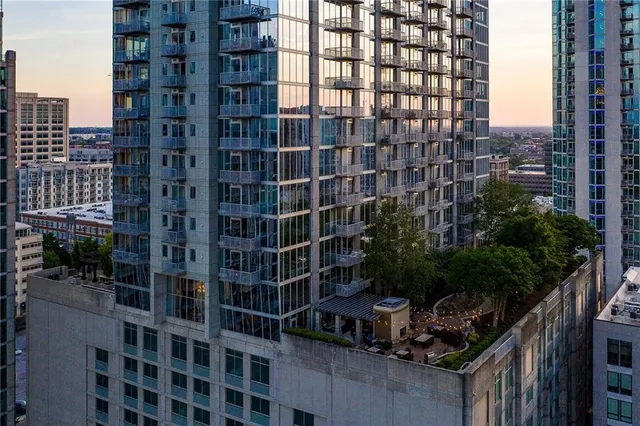 a living room with furniture kitchen view and a large window