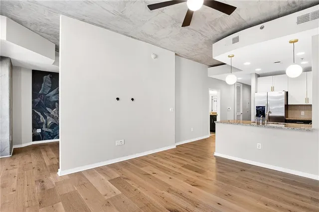 a view of a kitchen with a sink and a refrigerator