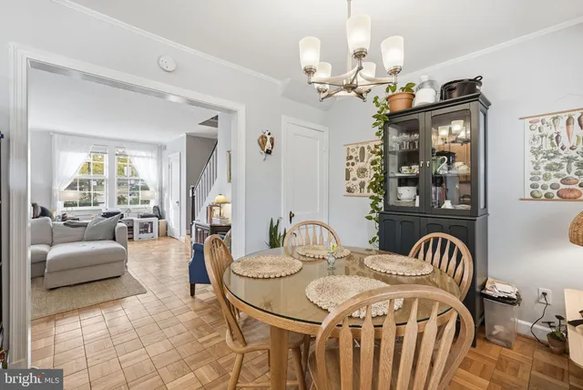 a view of a dining room with furniture and a chandelier
