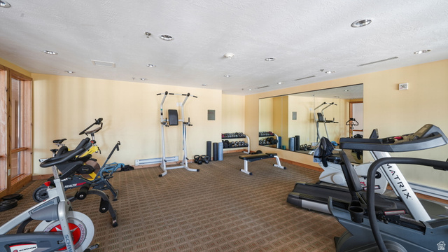1364 Still Water Drive, Unit R2012 Heber City, UT 84032 - Photo 26 of 30 Dedicated fitness area featuring patterned carpet flooring, recessed lighting, and a full-wall mirror