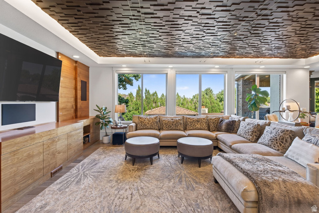 12308 Mariah Circle Draper, UT 84020 - Photo 26 of 293 Living room featuring a coffered ceiling with recessed lighting, a custom built-in entertainment center, and expansive windows