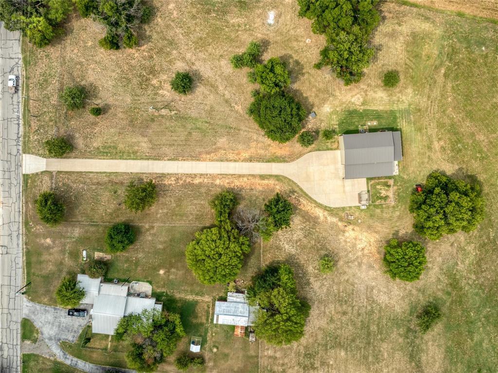 210 Spring Branch Trail North Springtown, TX 76082 - Photo 34 of 36 Expansive property featuring two distinct structures, a concrete driveway, and mature landscaping