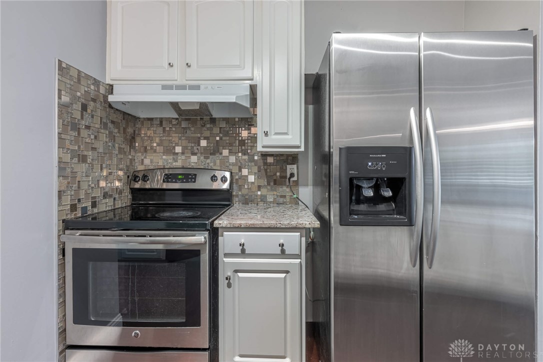 467 West Rahn Road Dayton, OH 45429 - Photo 11 of 41 This culinary space showcases a tiled backsplash and contemporary stainless steel appliances.