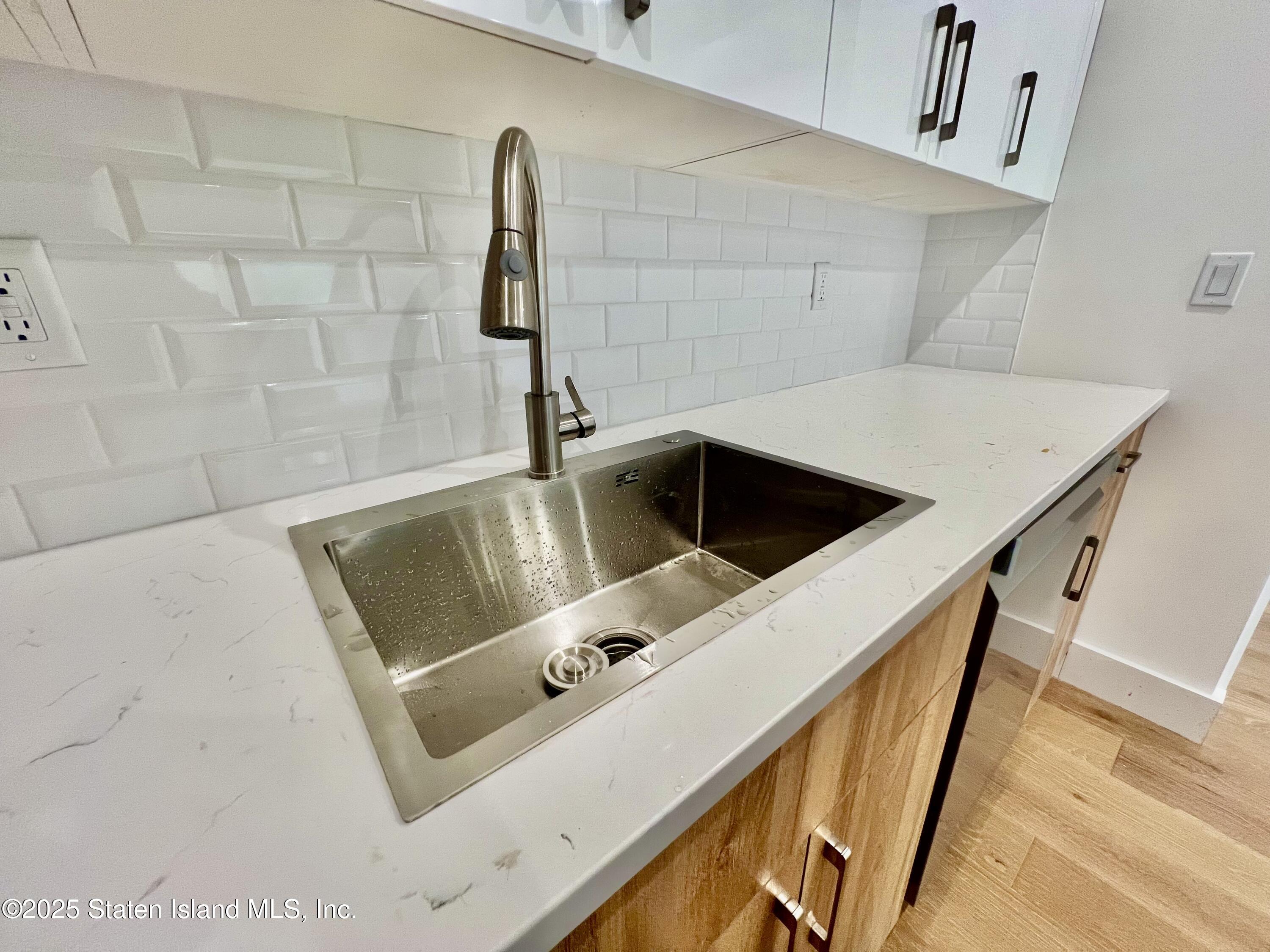 3865 Amboy Road, Unit 3D Staten Island, NY 10308 - Photo 12 of 36 a bathroom with a sink and mirror