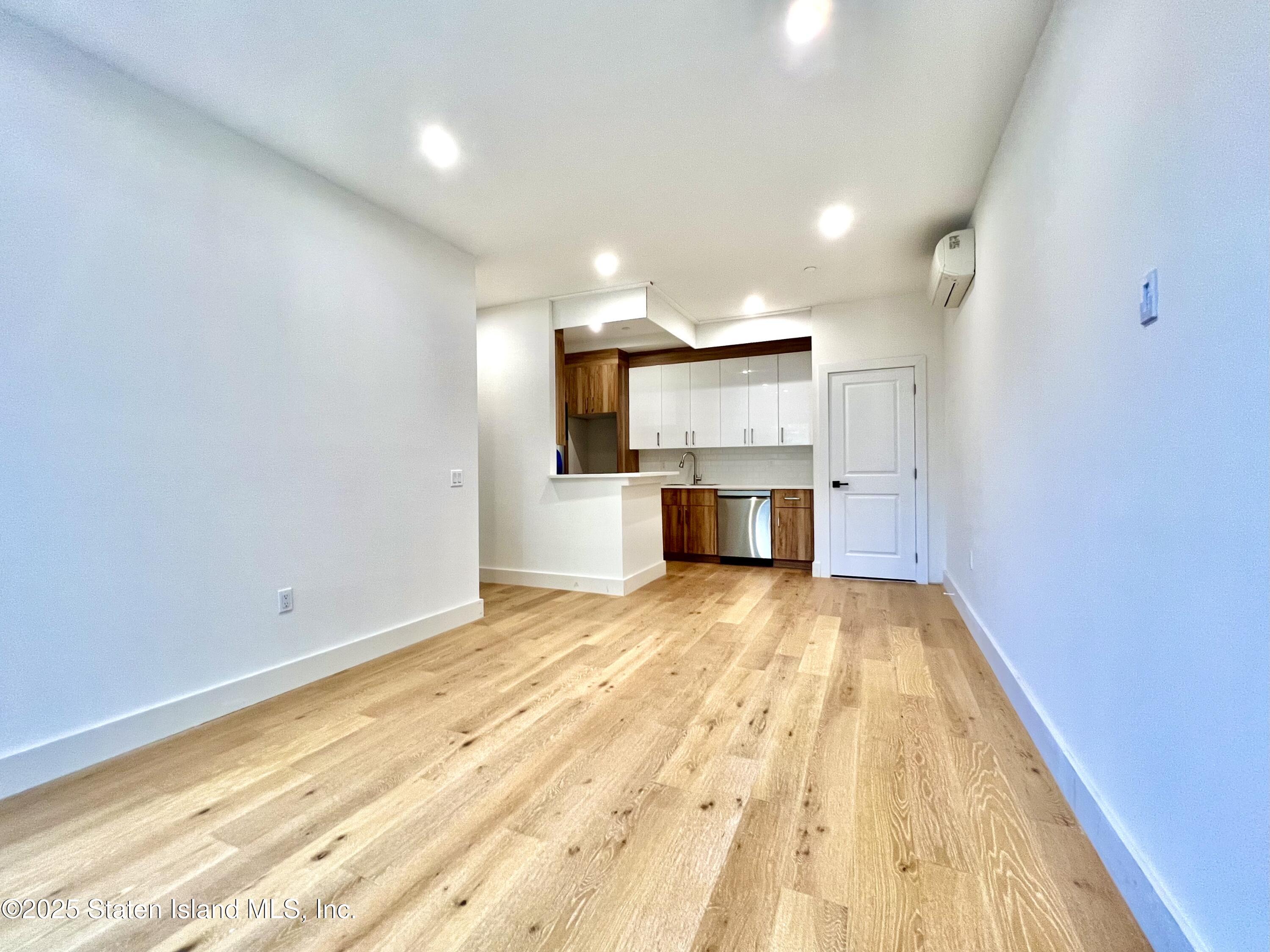 3865 Amboy Road, Unit 3D Staten Island, NY 10308 - Photo 15 of 36 a view of kitchen and empty room with wooden floor