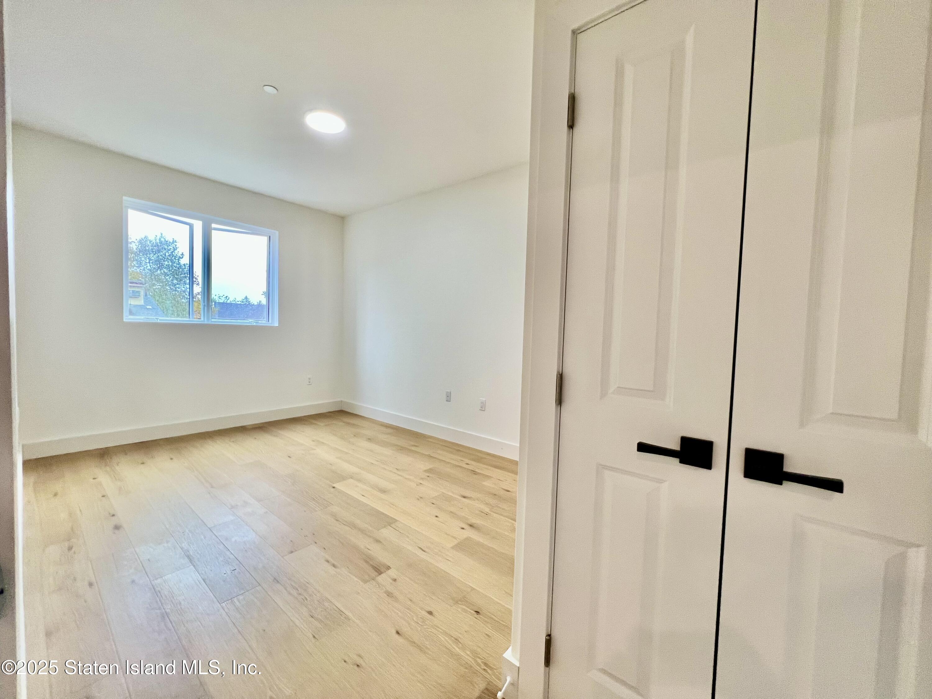 3865 Amboy Road, Unit 3D Staten Island, NY 10308 - Photo 24 of 36 a view of an empty room with a window