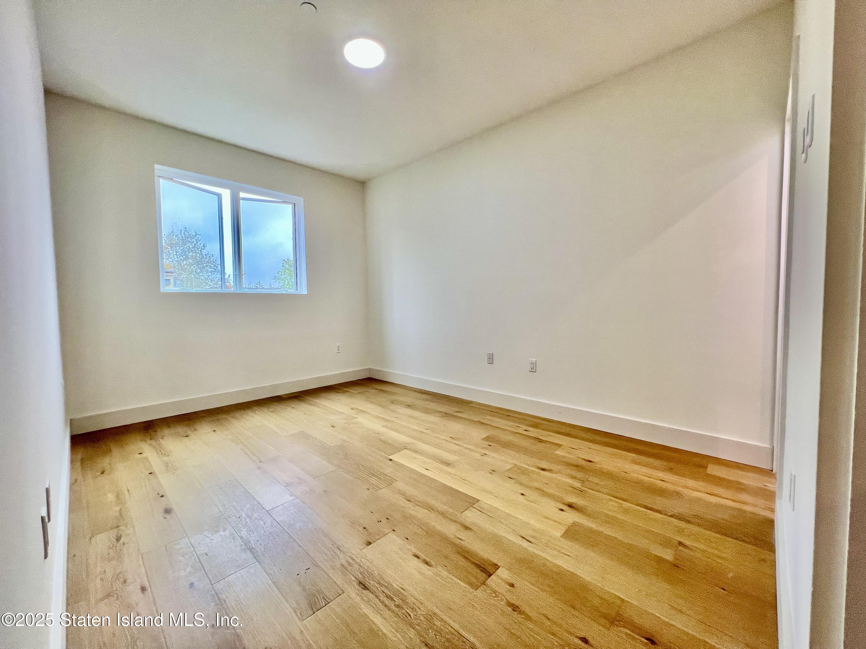 3865 Amboy Road, Unit 3D Staten Island, NY 10308 - Photo 25 of 36 a view of an empty room and wooden floor
