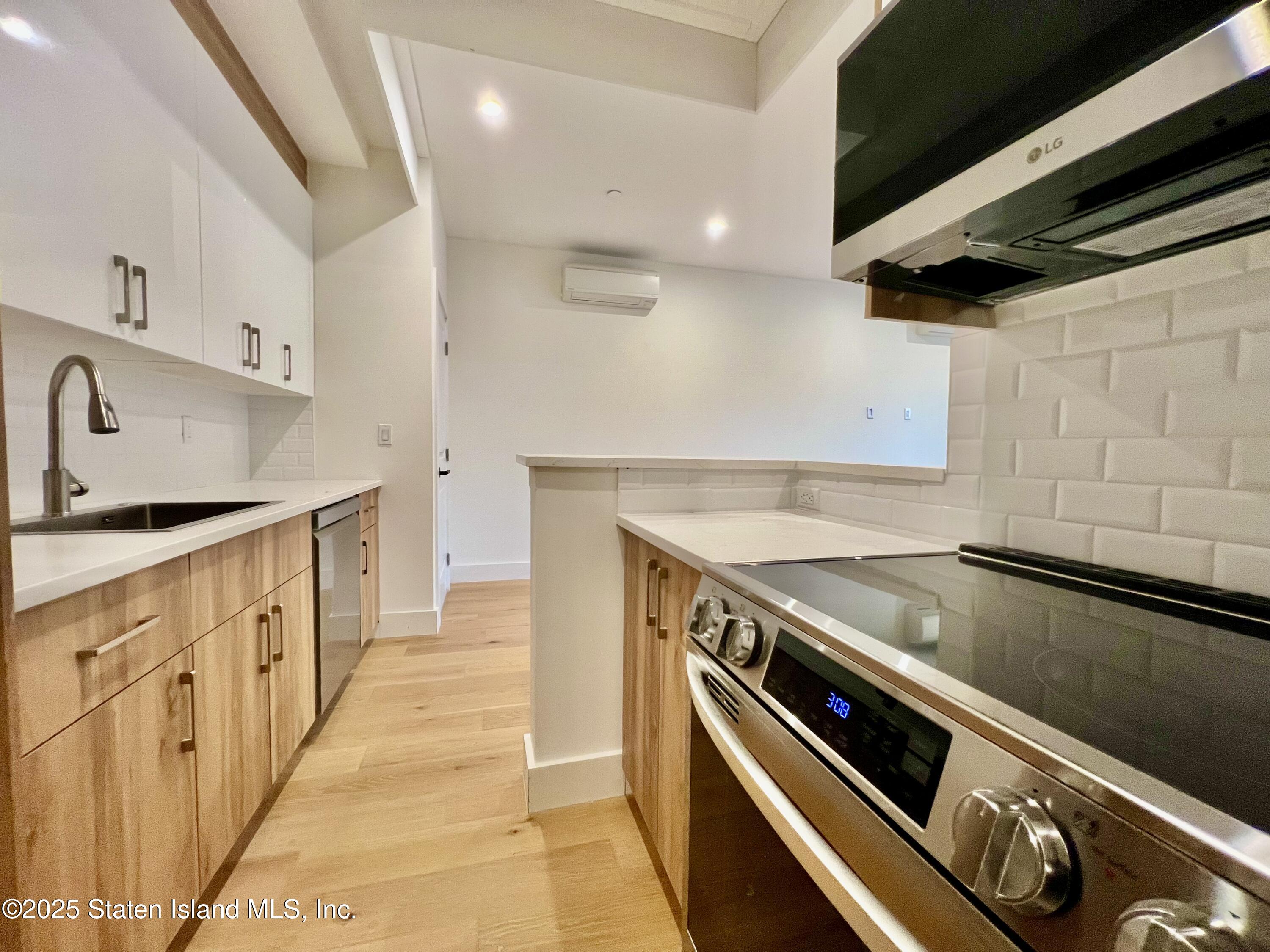 3865 Amboy Road, Unit 3D Staten Island, NY 10308 - Photo 9 of 36 a kitchen with granite countertop a sink and a stove
