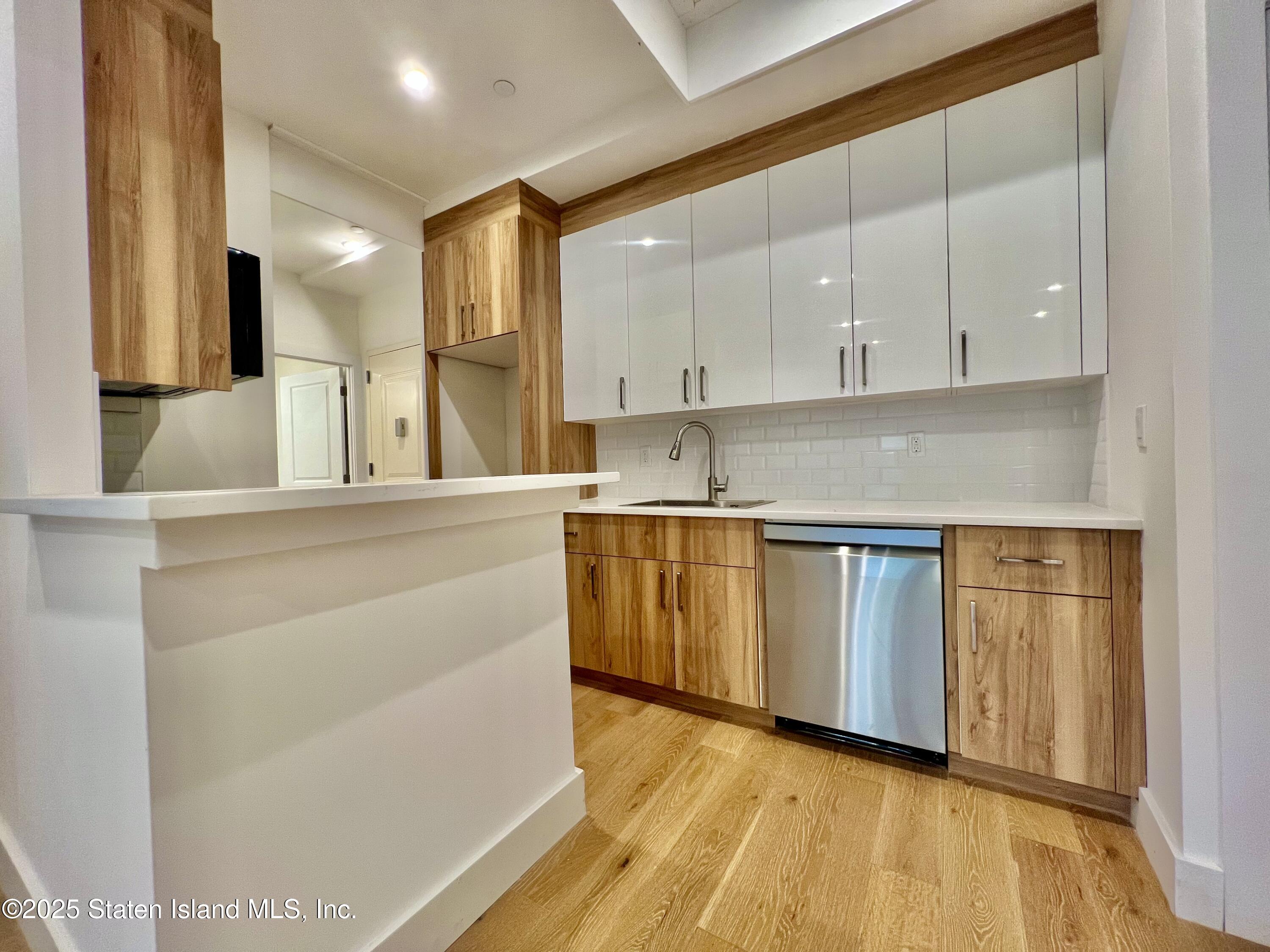3865 Amboy Road, Unit 3D Staten Island, NY 10308 - Photo 10 of 36 a kitchen with granite countertop a sink a stove and cabinets