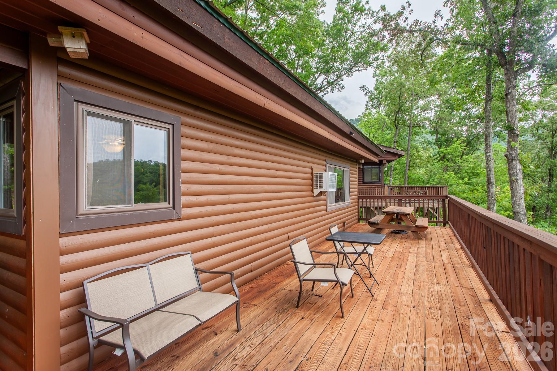 307 Blue Ridge Parkway Bryson City, NC 28713 - Photo 19 of 48 a balcony with wooden floor and outdoor seating