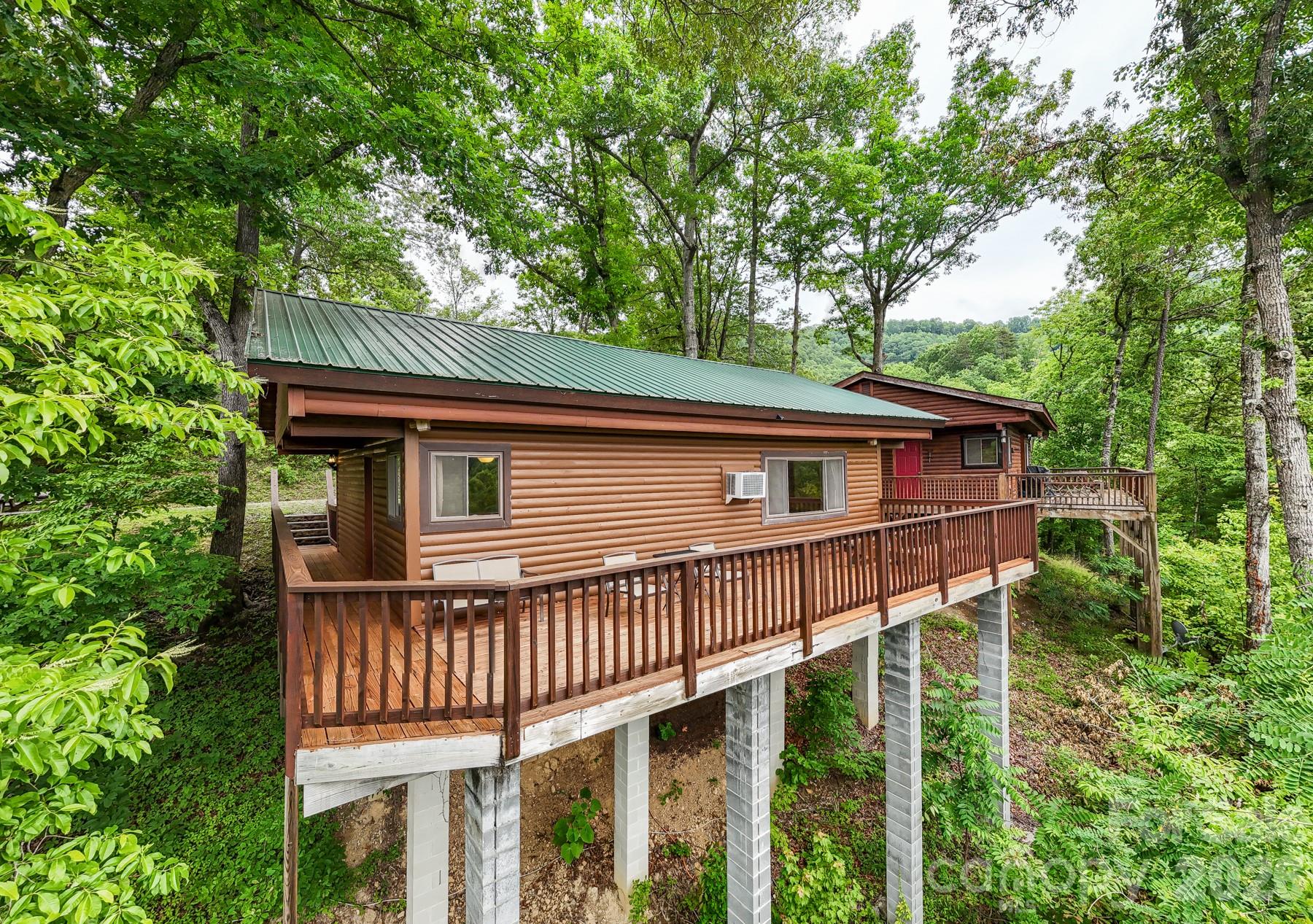 307 Blue Ridge Parkway Bryson City, NC 28713 - Photo 3 of 48 a view of backyard of house with wooden deck and seating space