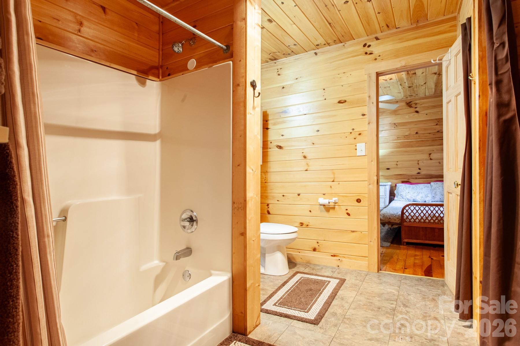 307 Blue Ridge Parkway Bryson City, NC 28713 - Photo 38 of 48 a bathroom with a bathtub and a shower