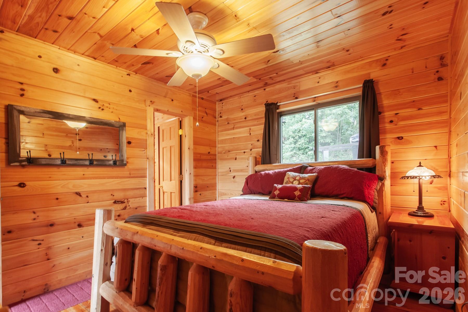 307 Blue Ridge Parkway Bryson City, NC 28713 - Photo 42 of 48 a bedroom with a bed and a flat screen tv