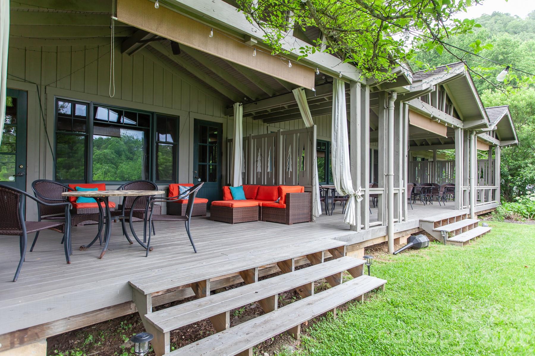 307 Blue Ridge Parkway Bryson City, NC 28713 - Photo 46 of 48 a view of a patio with table and chairs potted plants and a large tree