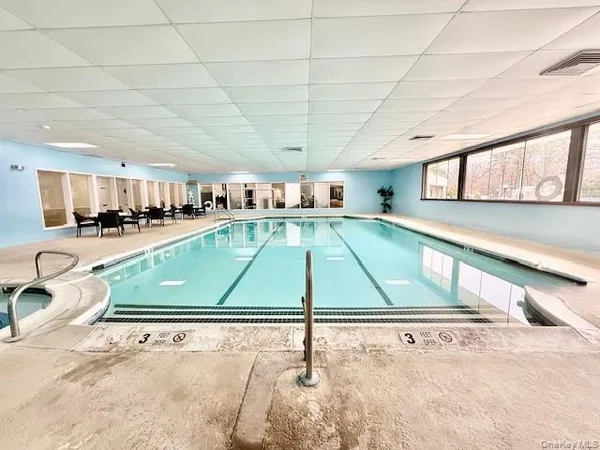a swimming pool view with a outdoor seating space
