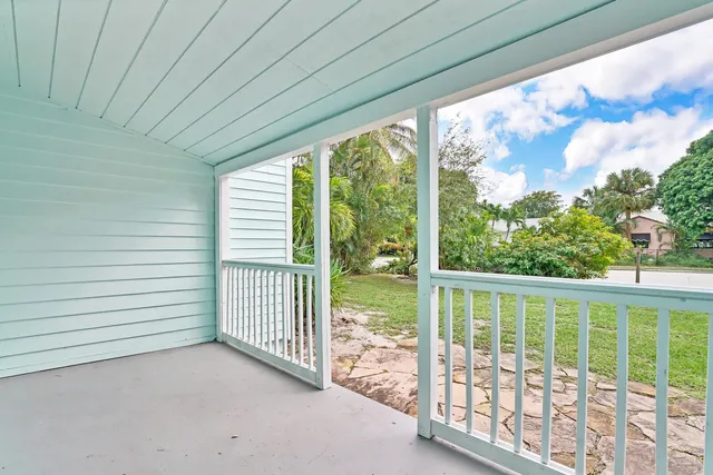 a view of a porch with a floor to ceiling window