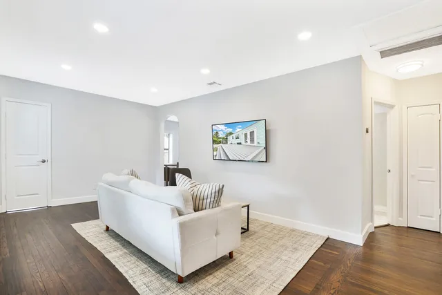 a living room with furniture and a wooden floor