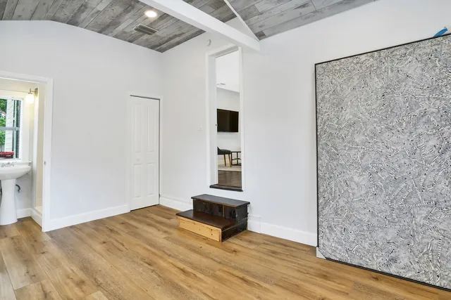 a view of a livingroom with wooden floor and a ceiling fan