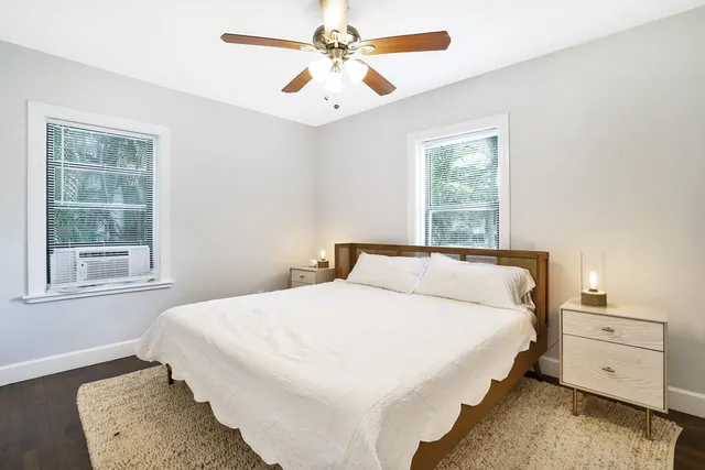 a bedroom with a large bed and a chandelier