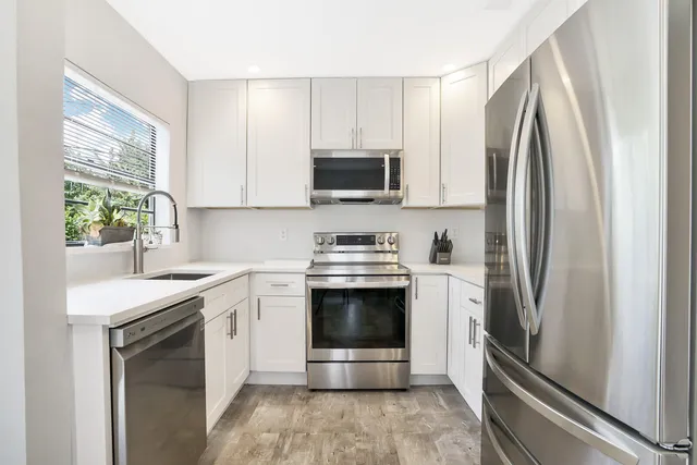 a kitchen with a stove sink and refrigerator