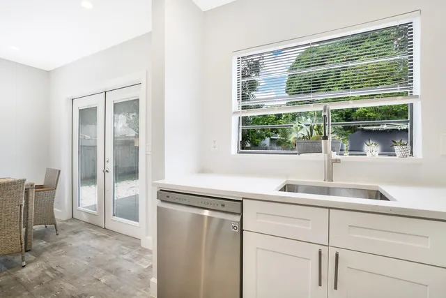 a kitchen with a sink and a large window
