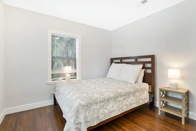 a bedroom with a bed and a window