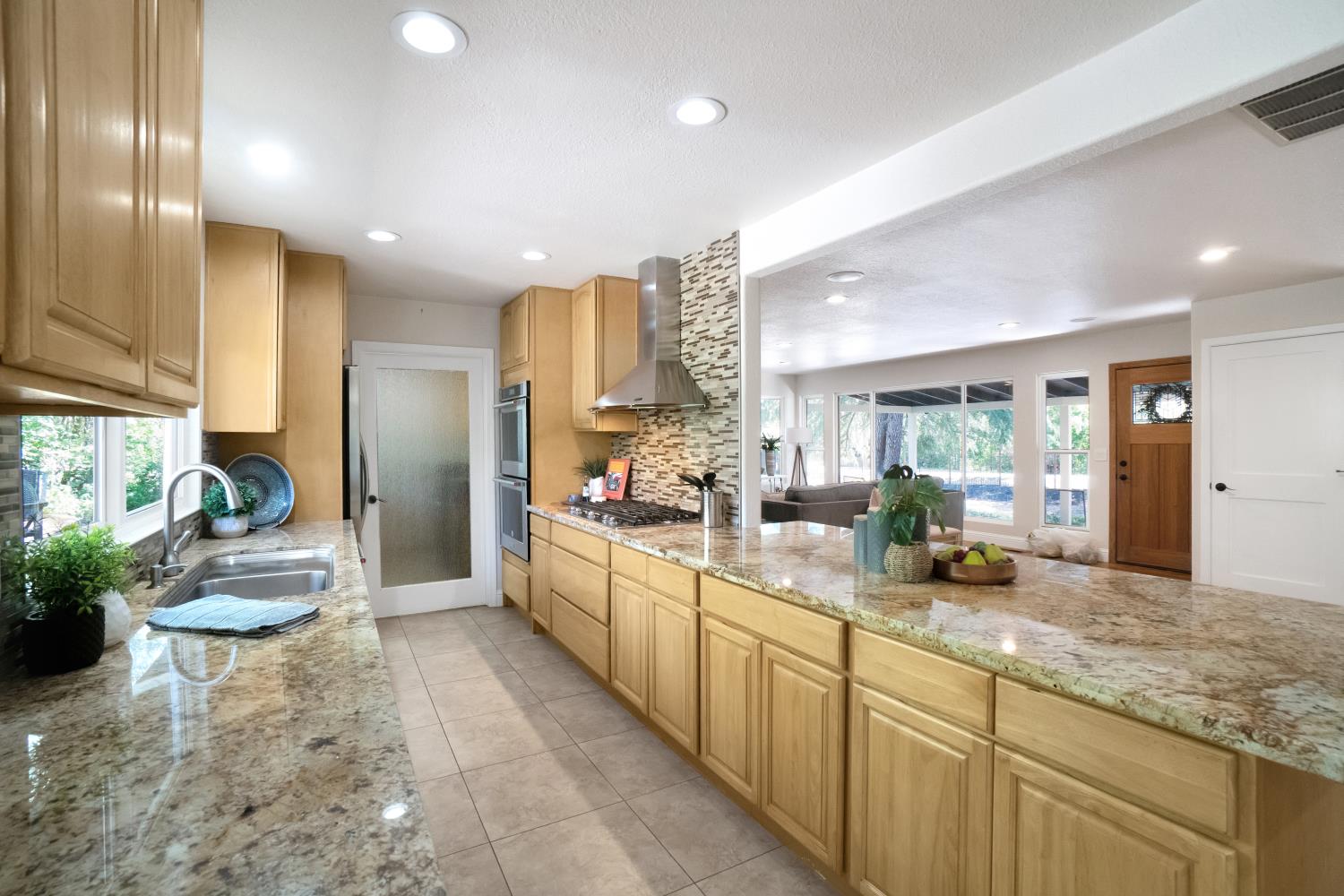 6299 Horseshoe Bar Road Loomis, CA 95650 - Photo 7 of 43 a view of a kitchen with kitchen island granite countertop lots of counter top space and stainless steel appliances