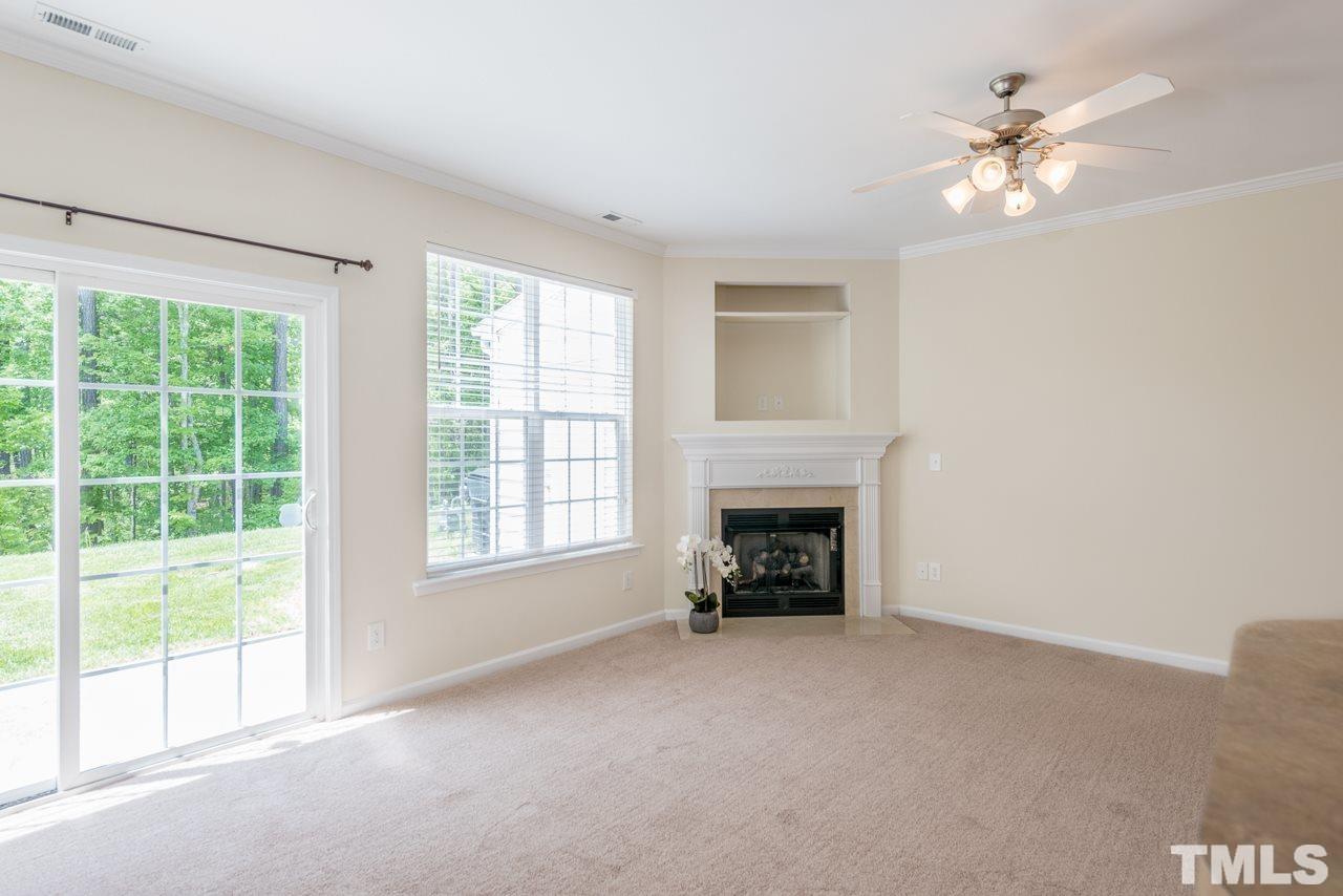 3535 Sugar Tree Place Durham, NC 27713 - Photo 2 of 8 an empty room with windows and fireplace