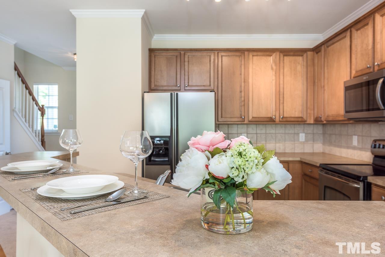 3535 Sugar Tree Place Durham, NC 27713 - Photo 5 of 8 a kitchen with a table and a potted plant