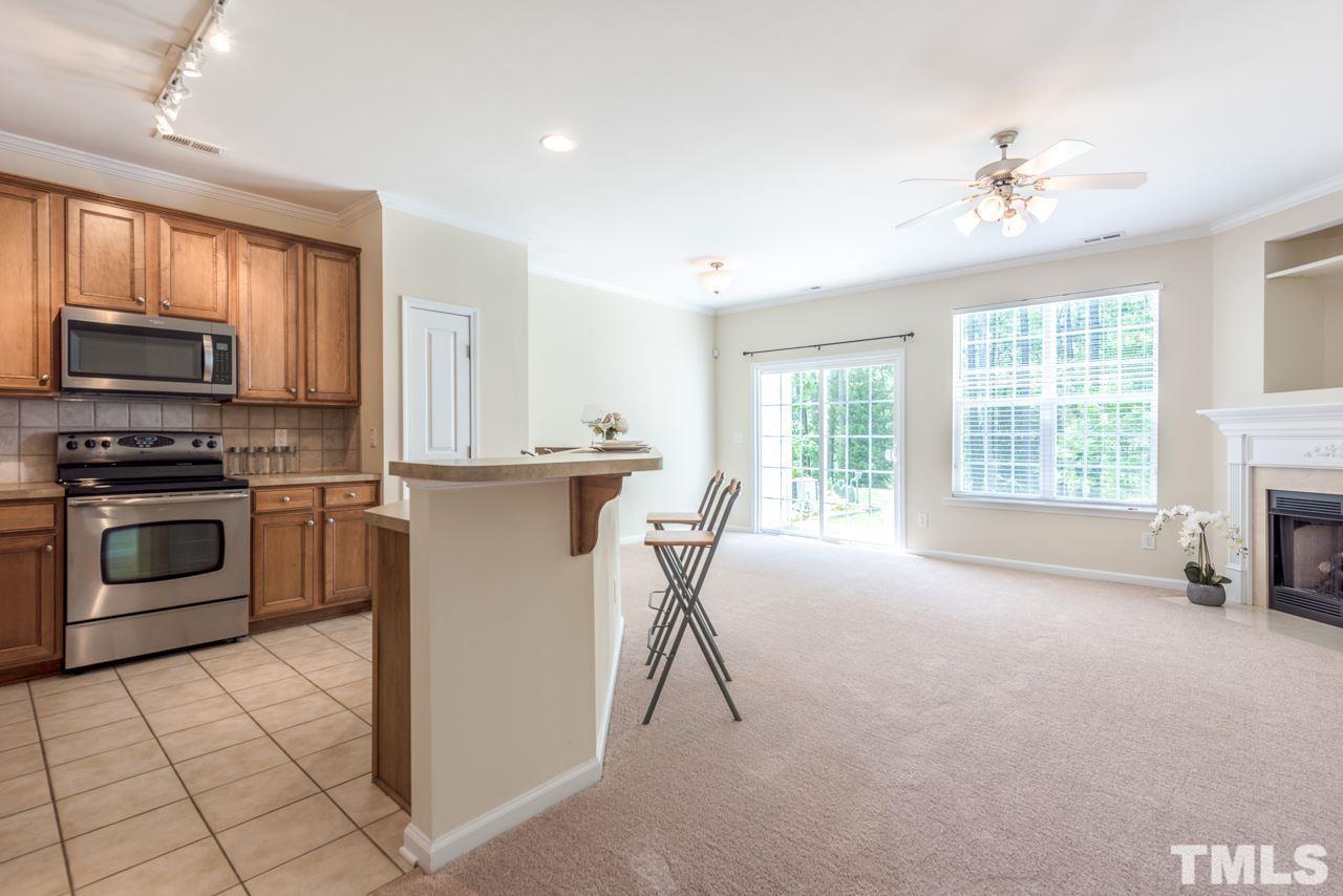 3535 Sugar Tree Place Durham, NC 27713 - Photo 6 of 8 a kitchen with a stove a sink and a microwave