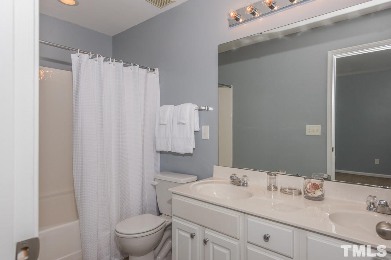 3535 Sugar Tree Place Durham, NC 27713 - Photo 7 of 8 a bathroom with a sink toilet and shower