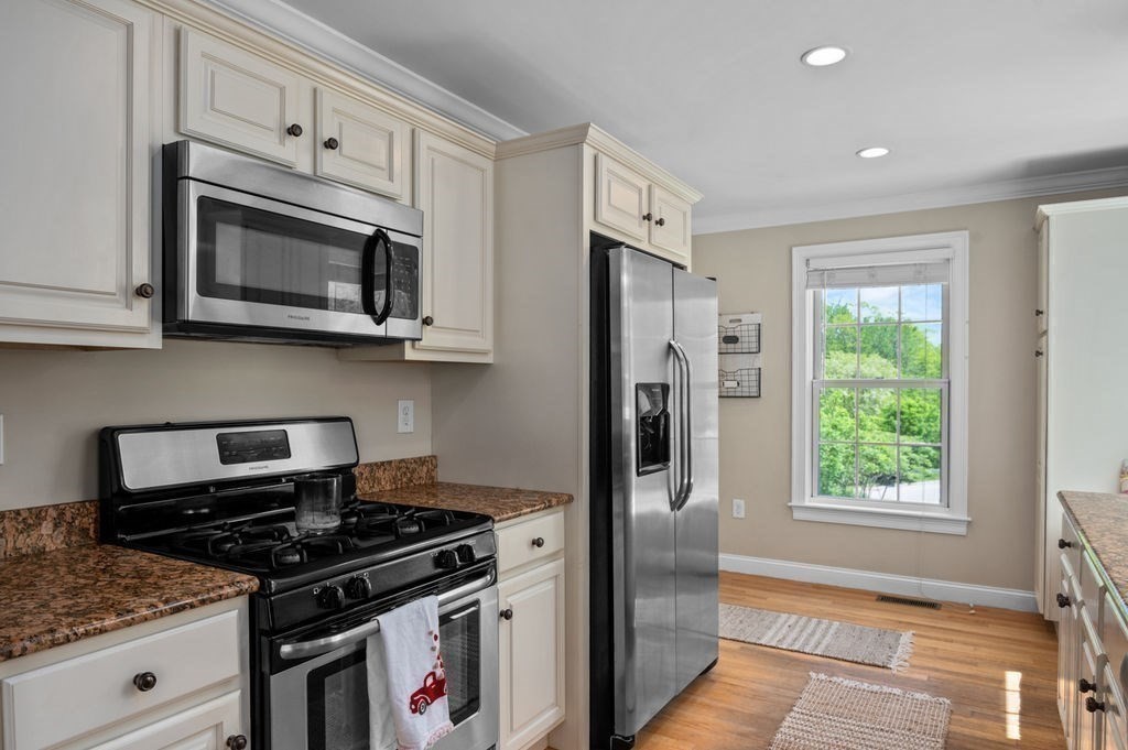 1 Timber Lane, Unit B Amesbury, MA 01913 - Photo 11 of 41 a kitchen with stainless steel appliances granite countertop white cabinets and a stove top oven