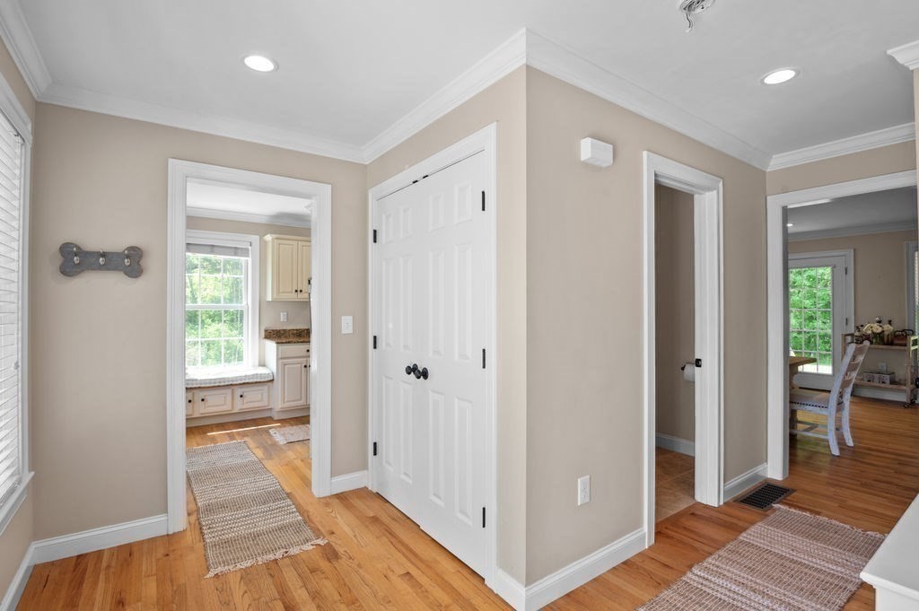 1 Timber Lane, Unit B Amesbury, MA 01913 - Photo 12 of 41 a view of a hallway with wooden floor and a bedroom