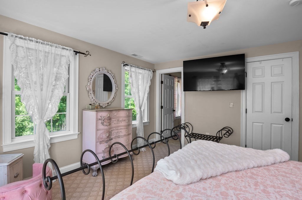 1 Timber Lane, Unit B Amesbury, MA 01913 - Photo 17 of 41 a bedroom with a bed a flat screen tv and windows