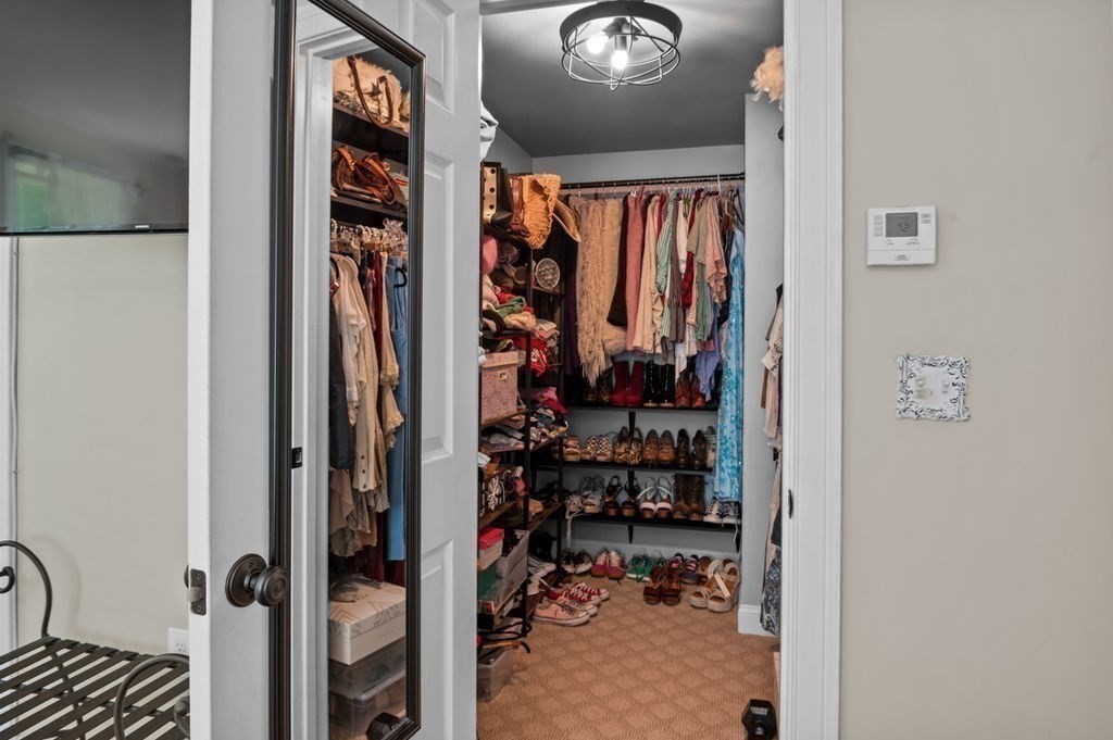 1 Timber Lane, Unit B Amesbury, MA 01913 - Photo 19 of 41 a view of walk in closet with clothes and shoes