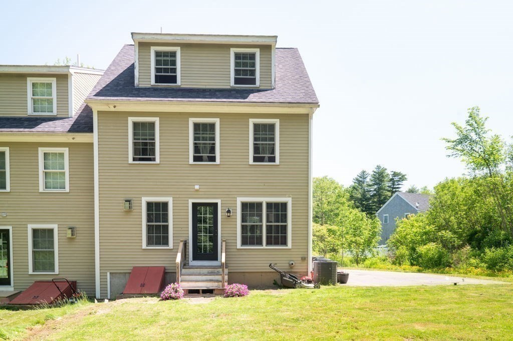 1 Timber Lane, Unit B Amesbury, MA 01913 - Photo 38 of 41 a view of a house with a yard and swimming pool