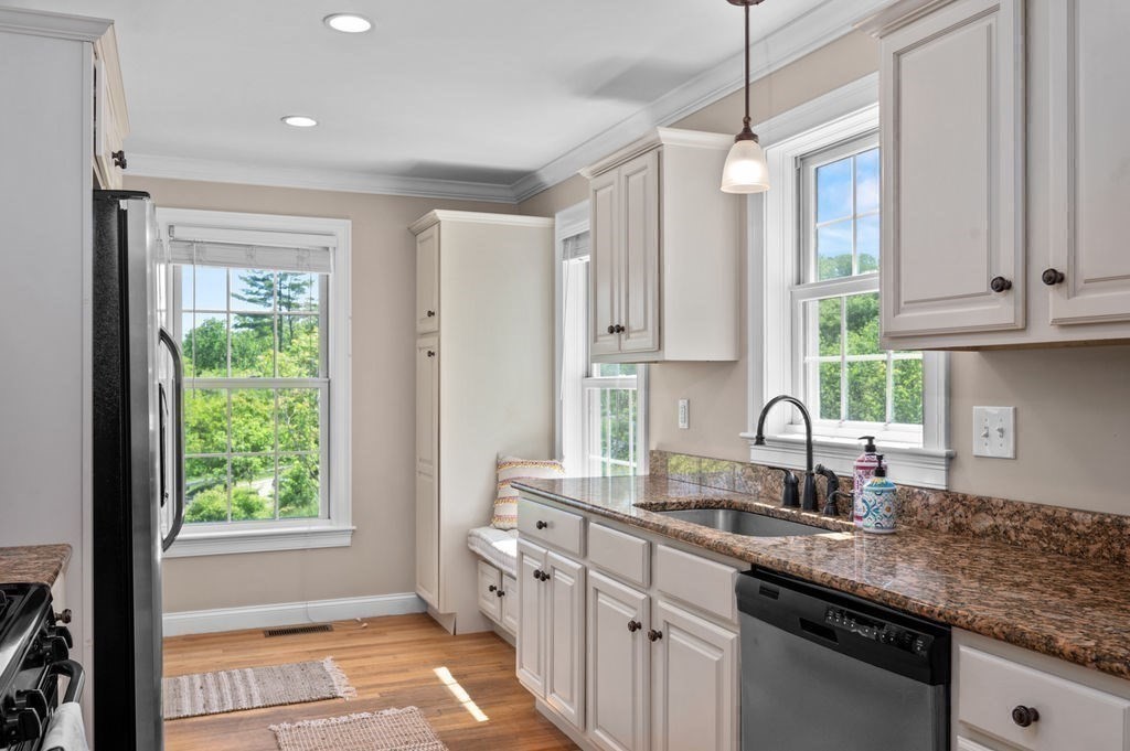 1 Timber Lane, Unit B Amesbury, MA 01913 - Photo 9 of 41 a kitchen with stainless steel appliances granite countertop a sink a stove and a window