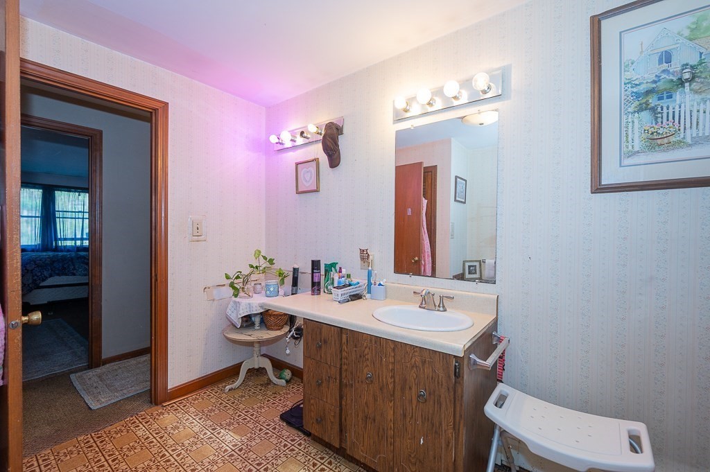 172 North Brookfield Road Oakham, MA 01068 - Photo 15 of 26 a bathroom with a sink a toilet and mirror