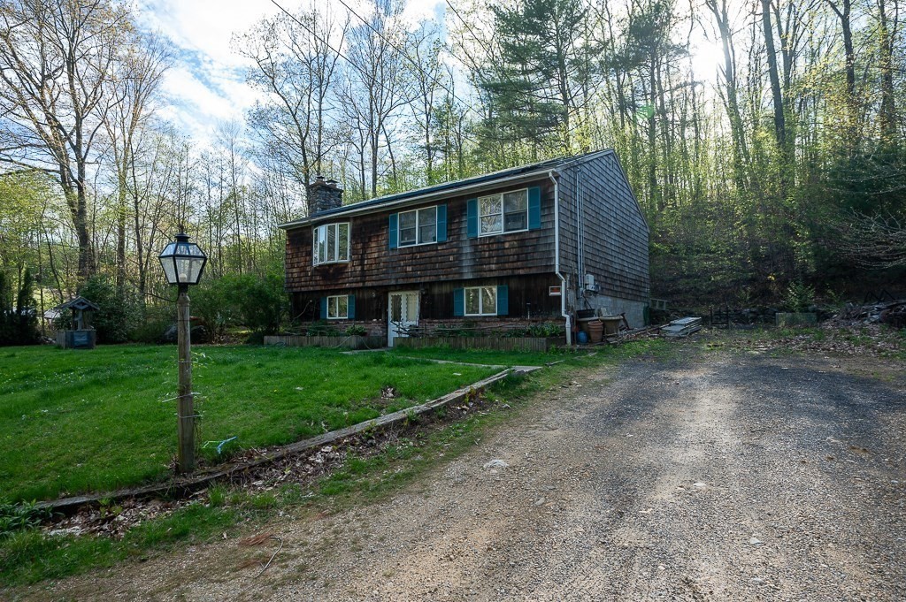 172 North Brookfield Road Oakham, MA 01068 - Photo 3 of 26 a front view of a house with garden