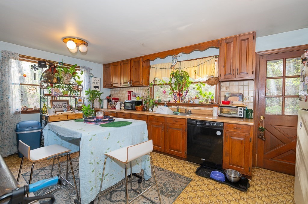 172 North Brookfield Road Oakham, MA 01068 - Photo 4 of 26 a kitchen with a stove a sink and a refrigerator