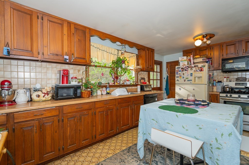 172 North Brookfield Road Oakham, MA 01068 - Photo 5 of 26 a kitchen with stainless steel appliances wooden cabinets granite counter tops and a window