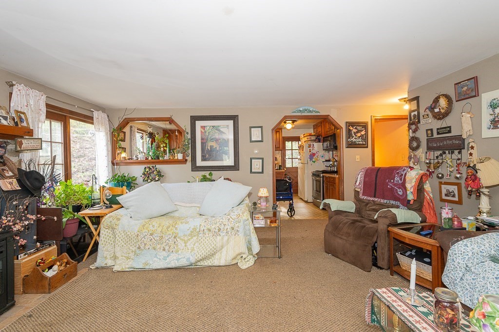 172 North Brookfield Road Oakham, MA 01068 - Photo 9 of 26 a living room with furniture and a fireplace