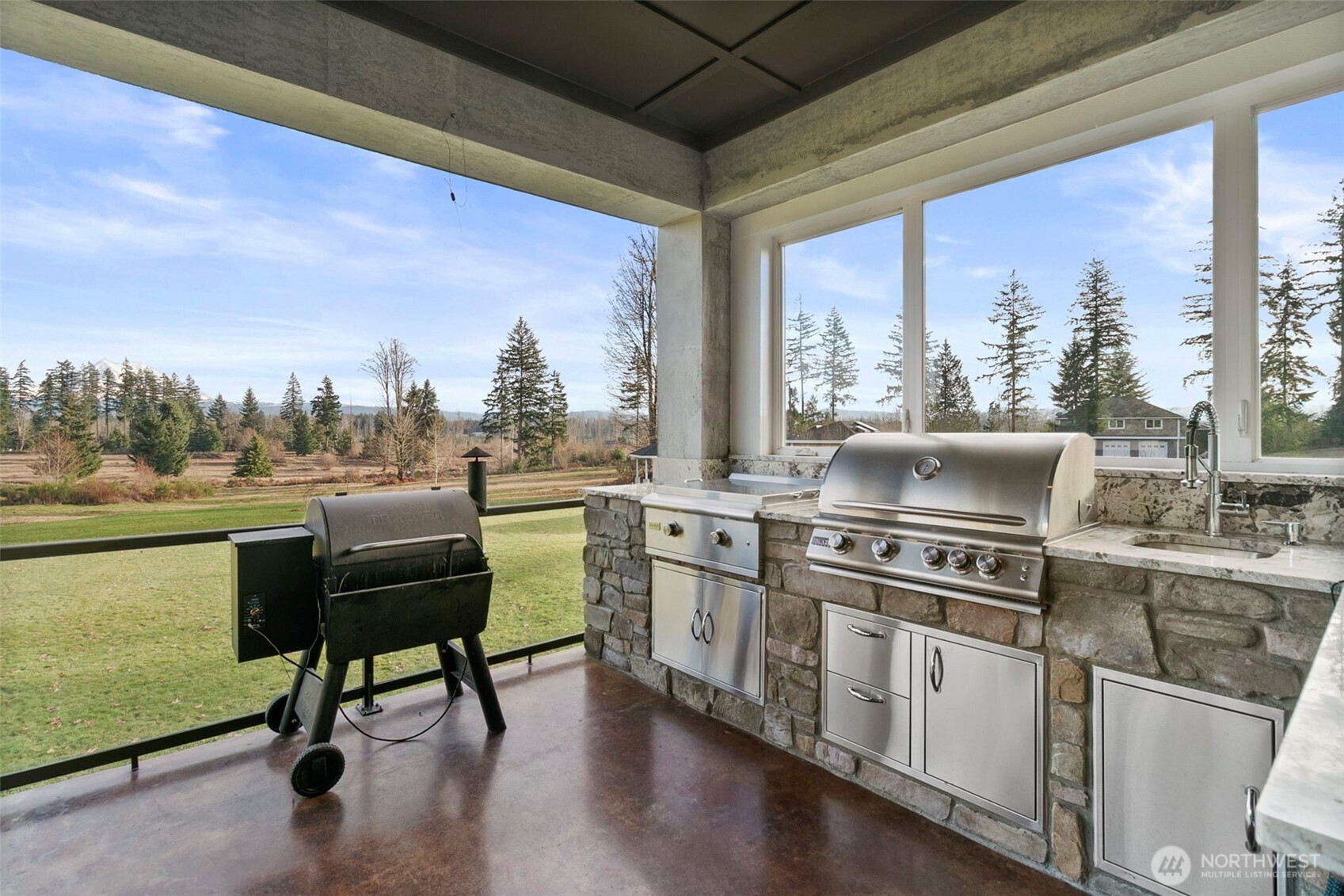 31619 26th Avenue East Graham, WA 98338 - Photo 13 of 40 a kitchen with a stove a sink and a refrigerator