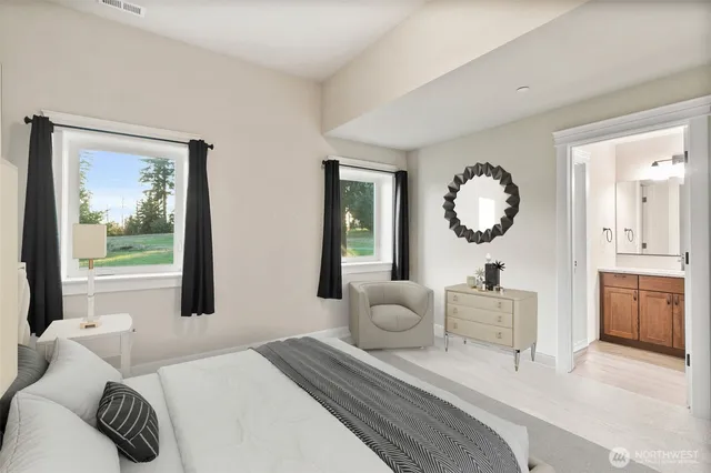 a bedroom with a large bed and a window