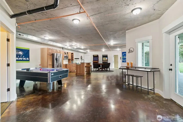 a room with lots of furniture and a wooden floor