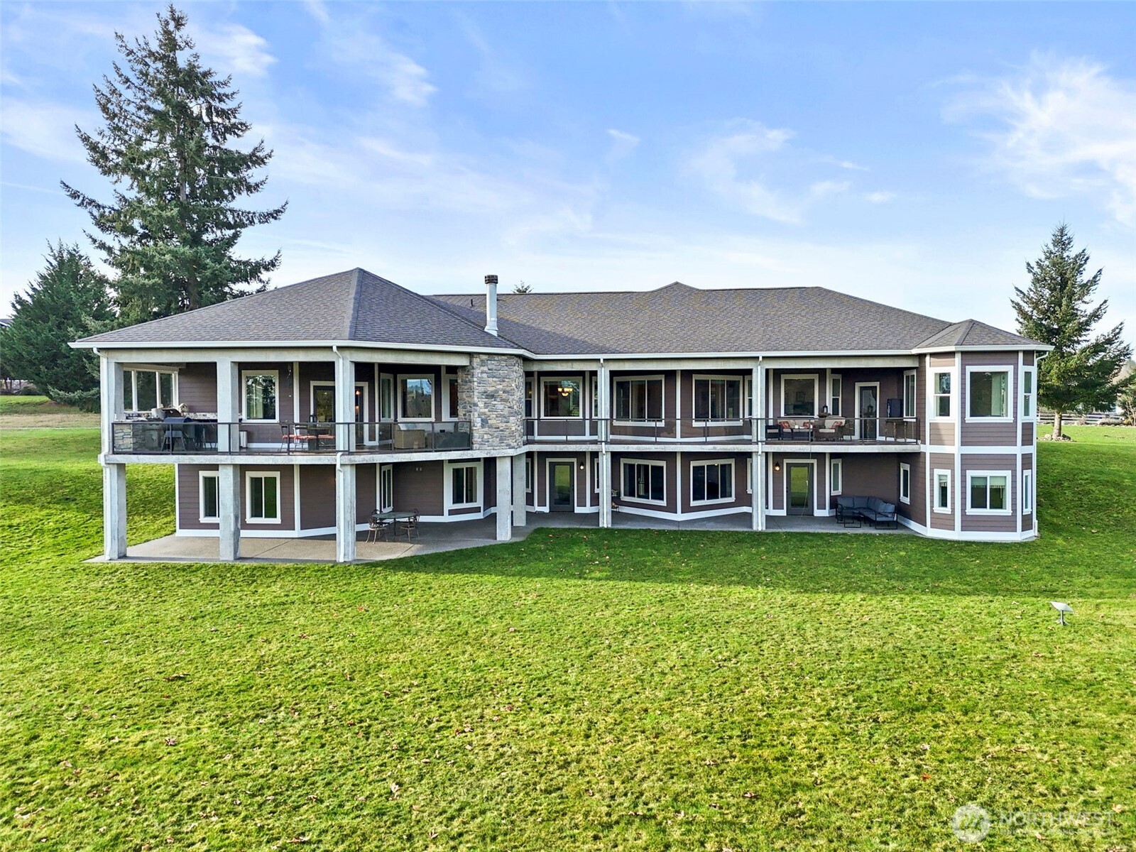 31619 26th Avenue East Graham, WA 98338 - Photo 34 of 40 a front view of a house with a garden and trees