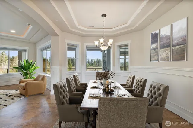 a dining room with furniture a chandelier and window