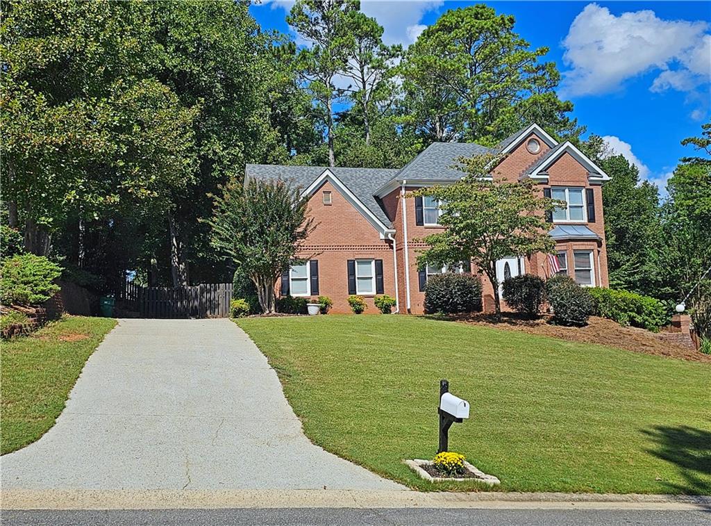 a front view of a house with a yard
