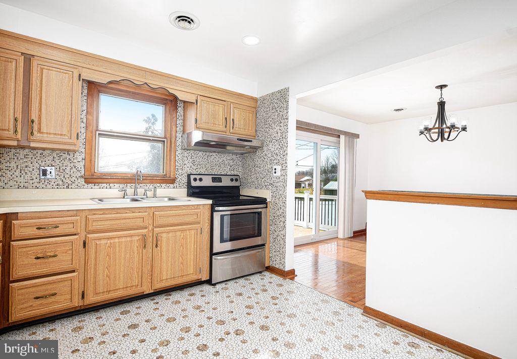 8007 Sagramore Road Baltimore, MD 21237 - Photo 13 of 41 a kitchen with granite countertop white cabinets and white appliances