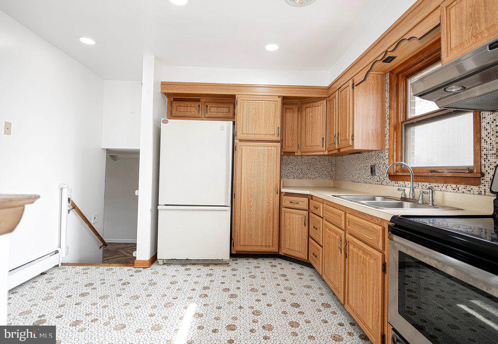 8007 Sagramore Road Baltimore, MD 21237 - Photo 14 of 41 a kitchen with a sink stove and refrigerator